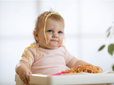 Baby with spaghetti on head