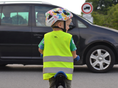 Child on bike wearing hi viz