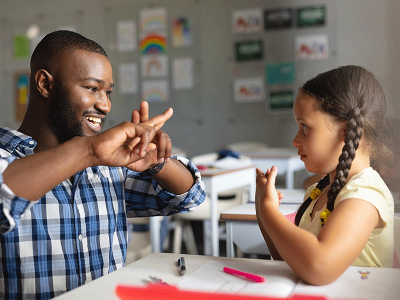 Teacher with student signing