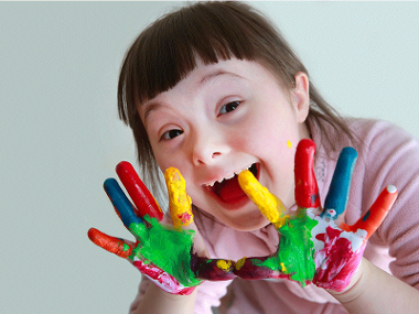 Happy girl with paint on her hands