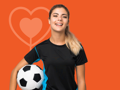  young women in sports wear with football